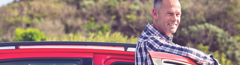 Man Standing Outside of a Vehicle