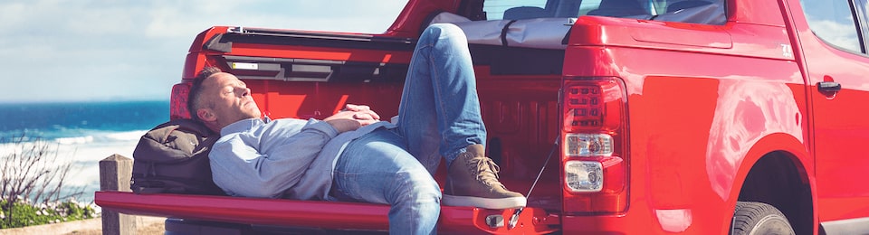 Man Lying on the Bed of a Truck